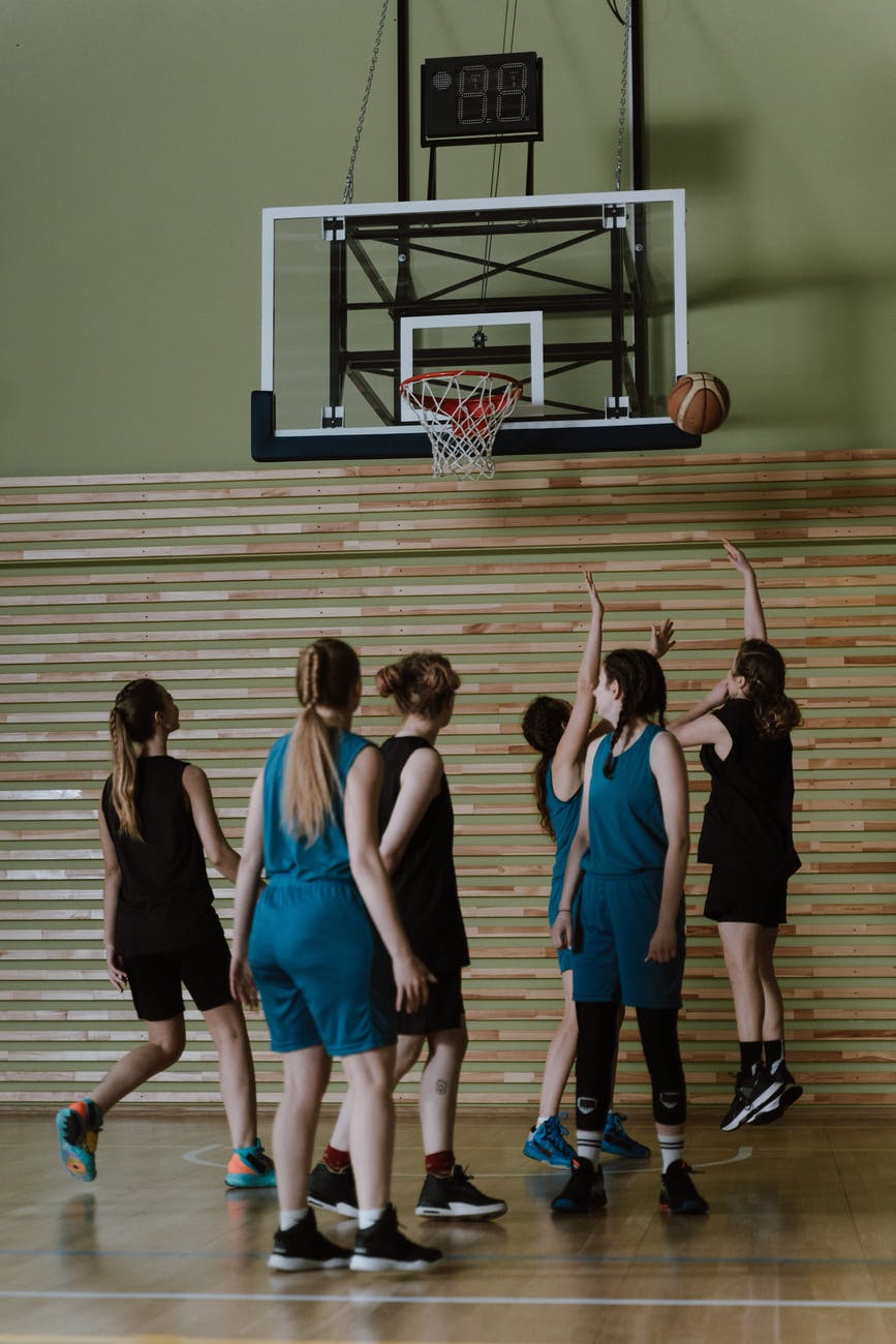 group of women playing basketball