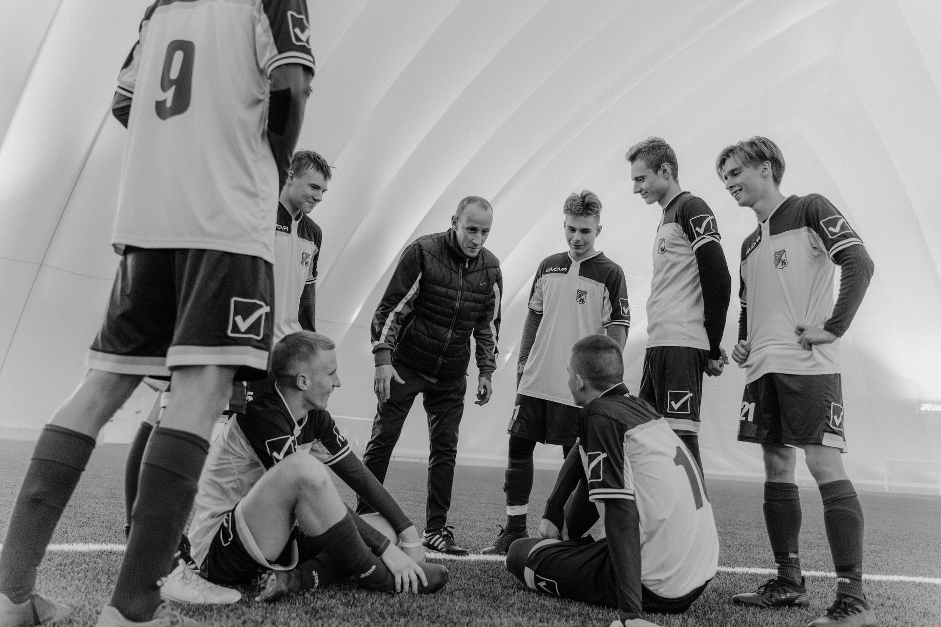 grayscale photo of men in soccer jersey
