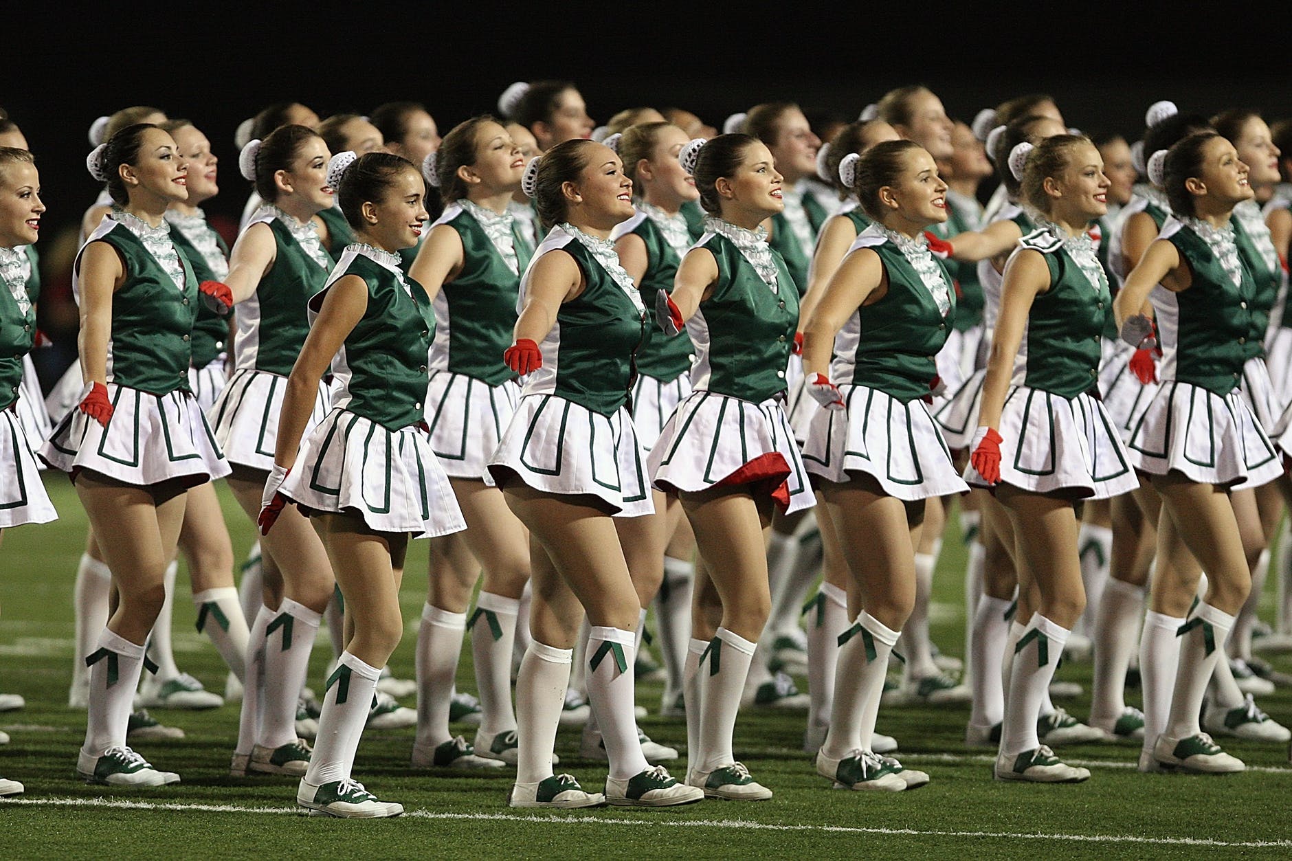 group of cheerleader on green field